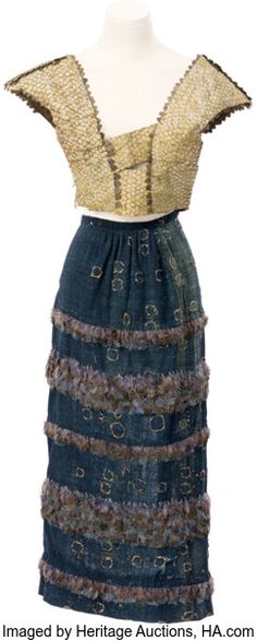 a dress made out of denim and gold sequins on a mannequin