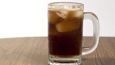 an iced beverage in a glass mug on a wooden table