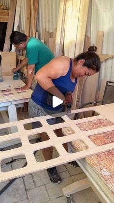 two women working on woodworking in a workshop