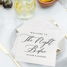 napkins with the words welcome to the night before are sitting on a white table cloth