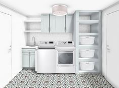 a white washer and dryer sitting in a room next to some cupboards