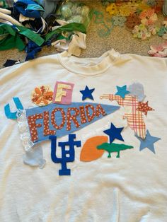 a t - shirt with the word florida on it, surrounded by stars and shapes