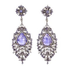 Pretty in Tanzanite White Sapphire & Diamond Dangle Earring is one of the gorgeous piece you would have in your jewelry collection. Closure: Push Post 18kt: 1.94gms Diamond: 2.31cts Slv: 18.7gms White Sapphire: 7.73cts TANZANITE: 15.76cts Tanzanite Diamond Earrings, Purple Dangle Earrings, Emerald Diamond Earrings, Earrings Sapphire, Premium Jewelry, Tanzanite Earrings, Sparkly Jewelry, Tanzanite Diamond, Earrings For Sale