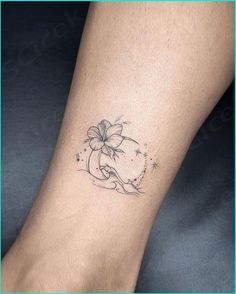 a woman's foot with a flower tattoo on the left side of her leg