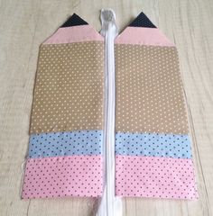 two pieces of fabric with polka dots on them sitting on top of a wooden table