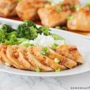 chicken, broccoli and rice on a plate with chopsticks next to it