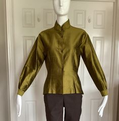 "Romeo Gigli in the early 1990s designed for Callaghan using the same elegant fabrics that he used in his own line.  This blouse is 109% silk shantung.  From my private Romeo Gigli collection. Unworn. Pristine.  Size I44, USA8 Mandarine collar.  Long sleeves.  Made in Italy Excellent workmanship. Made by Zamasport, the same factory in Italy that made his own line.  Finished interior seams. No raw edges.  Front button closure.  Side seam slits. Asian feel to this blouse.  Double pleats at the cuf Designer Long Sleeve Green Tops, Green Stand Collar Tops For Fall, Green Stand Collar Top For Fall, Designer Green Long Sleeve Tops, Fall Blouse With Stand Collar, Elegant Stand Collar Tops For Fall, Formal Stand Collar Top For Fall, Traditional Green Blouse For Evening, Traditional Green Evening Blouse