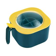 a yellow and blue bowl with a handle on the side, sitting in front of a white background