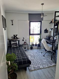 a bedroom with a bed, desk and shelves in it's corner area next to a window