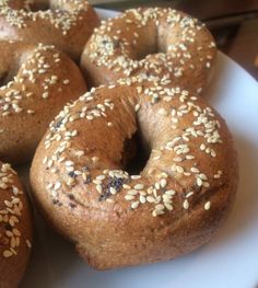 sesame seed bagels on a white plate