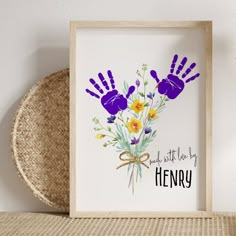 a hand print with flowers in it on a shelf next to a wicker basket