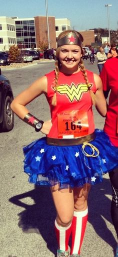 two women dressed up in costumes for a race run, one is wearing a red shirt and the other has a blue skirt