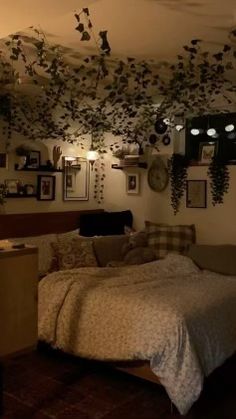 a bed room with a neatly made bed and lots of hanging plants on the wall