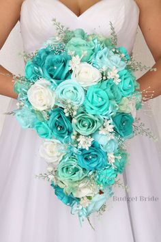 a bride holding a bouquet of blue and white flowers