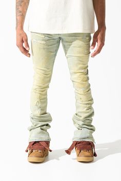 The "TIERRA" jeans feature a gold dyed wash (vintage blue with yellow tint) with a skinny fit and a stacked finish. Go with your regular waist size. This style fits like our usual sizing with added stack to the bottom of the leg. THIS STYLE IS A STACKED JEAN AND HAS A WIDER LEG OPENING. PLEASE ORDER YOUR USUAL SIZE FOR THIS PARTICULAR LOOSER FIT AROUND YOUR LEGS. DETAILED FEATURES: Stretchability: MEDIUM STRETCH Vintage blue denim base layered with a gold dye wash (yellow tint) Distressing throu Urban Style Fitted Faded Bottoms, Fitted Acid Wash Stonewashed Jeans, Fitted Acid Wash Jeans With Five Pockets, Fitted Acid Wash Bottoms With Five Pockets, Fitted Stonewashed Faded Jeans, Yellow Straight Leg Jeans With Five Pockets, Yellow Straight Leg Jeans For Streetwear, Acid Wash Fitted Bottoms For Streetwear, Fitted Acid Wash Bottoms For Streetwear