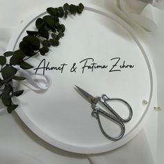 a pair of scissors sitting on top of a white sign that says annet & prima zora