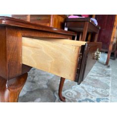 a wooden table with drawers on top of it