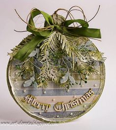 a christmas ornament hanging from a green ribbon