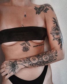 a woman with tattoos on her chest and arm