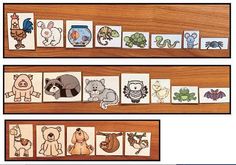 four different animal matching cards on a wooden surface, with the same one being cut out