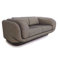 a gray couch sitting on top of a white floor