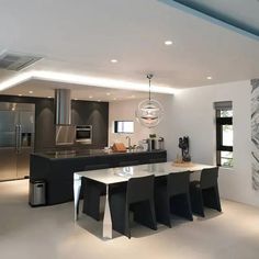 a modern kitchen with an island and stainless steel appliances