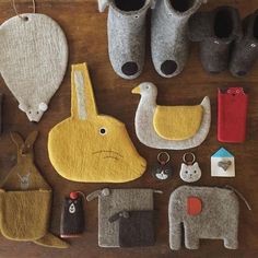 several felt animals and accessories laid out on a table