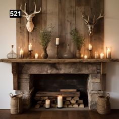 the fireplace is decorated with candles and deer heads