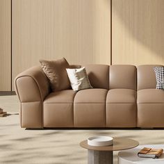 a living room with beige leather furniture and pillows