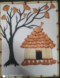 an art project made out of paper with a tree and birdhouse on the side