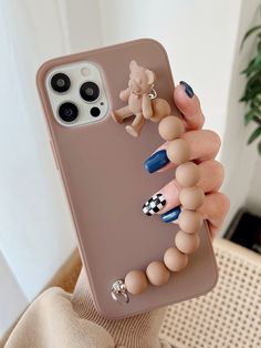 a woman is holding up her phone case