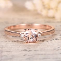 an oval morganite ring with three diamonds on top