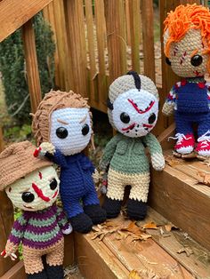 three crocheted dolls are sitting on the steps