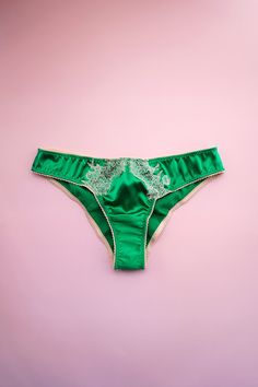 The beloved Ophelia panty now comes in a vibrant Emerald Green color stretch silk with barely there beige lace. Trimmed with beige picot elastic, and ruching down the back. Cheeky back brief. Handmade to order in California. This delicate item is handmade to order, please allow 6-8 weeks before it ships. Fit: Cheeky back low rise. Material: Stretch Silk 95% Silk/5% Spandex, Nylon laceCare: Hand wash in cold water, hang or lay flat to dry. Dry clean ok. Wash separately. SIZE CHART SHIPPING / RETU Cheap Green Fitted Intimates, Bra Art, Perfect Honeymoon, Luxury Nightwear, Bra Fitting Guide, Emerald Green Color, Virtual Closet, Green Lace, White Silk