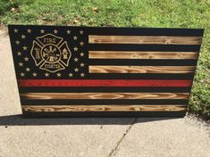 an american flag made out of wood with fire department emblem on the front and side