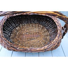 an empty basket sitting on top of a wooden floor