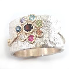 Handcrafted flower design ring, silver gold flower ring set with Garnet, Peridot, CZ, Amethyst, Rubi, Champagne CZ, Blue topaz, Sapphire. The sterling has an amorphous texture that looks like crumpled tinfoil. spring motif Engagement ring. Gemstone options: Red Garnet / peridot / CZ / Amethyst / Rubi / Champagne CZ / Blue topaz / Sapphire / turquoise / opal. Measurements: Width: 0.48 inch / 12 mm Thickness: 0.06 - 0.08 inch / 1.5-2 mm Garnet diameter: 0.12 inch / 3 mm Gems diameter: 0.08 inch / Gold Topaz Ring, Engagement Ring Gemstone, Gold Flower Ring, Funky Jewelry, Gold Flower, Ring Gemstone, Red Garnet, Topaz Ring, Flower Ring