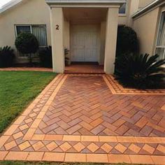 a brick walkway in front of a house