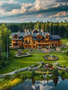 an aerial view of a large wooden house in the middle of a lush green field