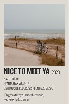 a bike parked on the side of a sandy beach next to the ocean with words written below it