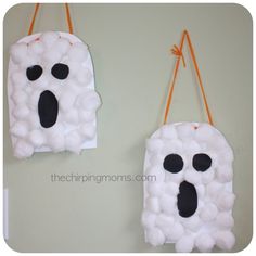 two halloween decorations made to look like they are hanging on the wall with strings attached