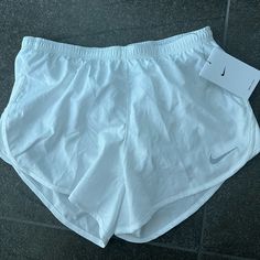 Nike Dri Fit Shorts White Size Small New With Tags Nike Short Leg Bottoms For Summer, Summer Nike Shorts, Nike Beach Shorts With Stretch, Nike Beach Shorts, Nike Summer Sports Bottoms, White Nike Bottoms For Beach, White Nike Shorts With Pockets, Nike White Short Leg Bottoms, Nike Dri Fit Shorts