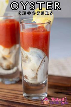 two glasses filled with food on top of a wooden table