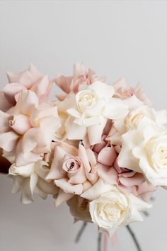 a bouquet of white and pink flowers in a vase