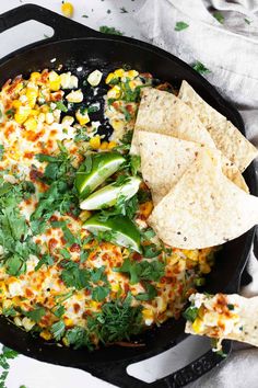 a skillet filled with mexican food and tortilla chips