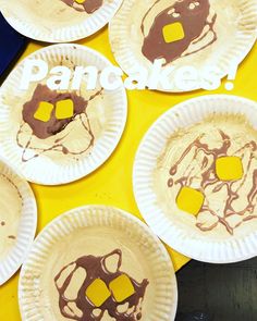 paper plates that have some kind of pancake on them with yellow and brown icing