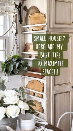 a kitchen with white flowers on the table and green sign that says, small house? here are my best tips to maximum space