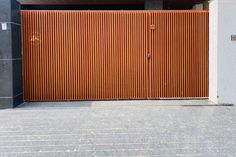 an open garage door on the side of a building that is made out of metal slats