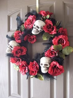 a wreath with skulls and flowers on the front door