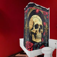 a shower curtain with a skull and roses on it is next to a toilet in a bathroom